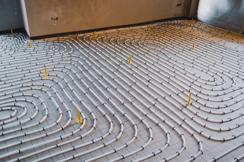 Installing,Underfloor,Heating,System,Consisting,Of,Plastic,Pipes,Fixed,On