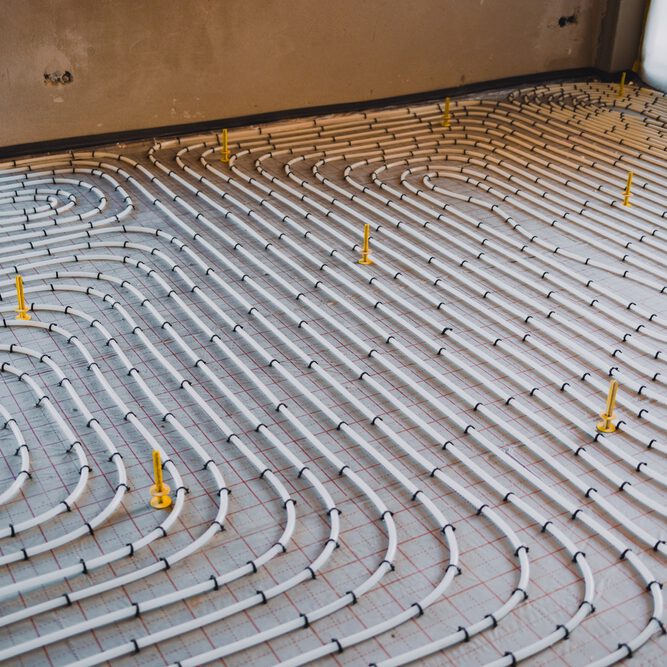 Installing,Underfloor,Heating,System,Consisting,Of,Plastic,Pipes,Fixed,On
