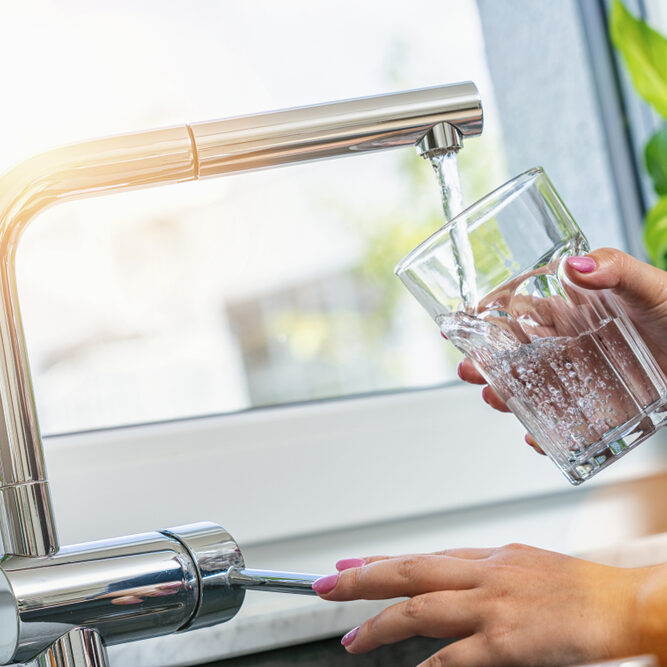 Woman,Holding,Glass,At,Water,Tap,And,Filling,Water